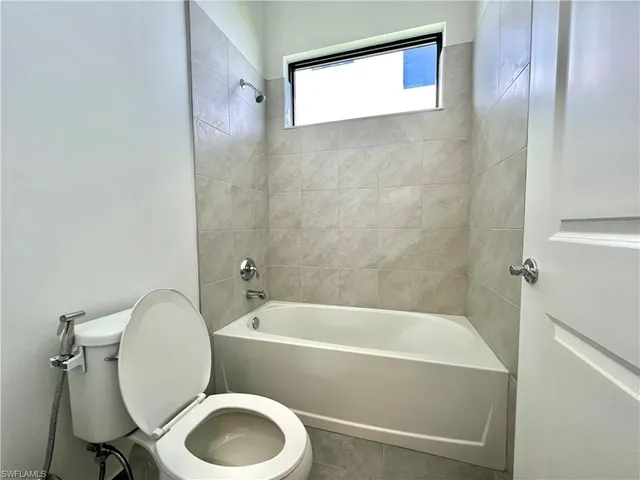 a bathroom with a toilet and a bathtub
