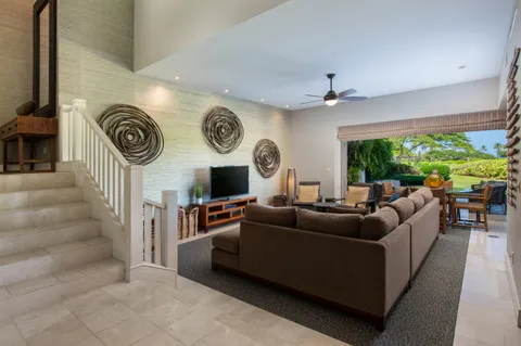 a living room with furniture and a clock
