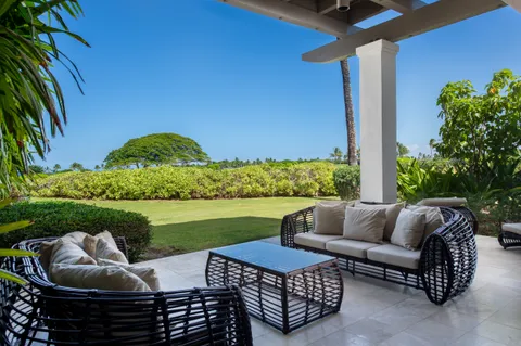 a view of patio with couches table and chairs with potted plants