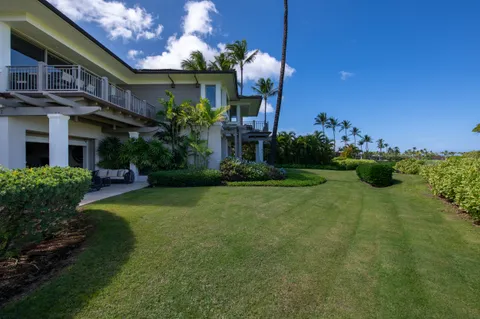 a front view of a house with a yard garage and outdoor seating