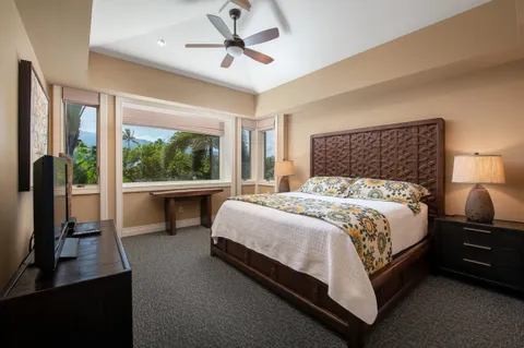 a bedroom with a large bed and a large window