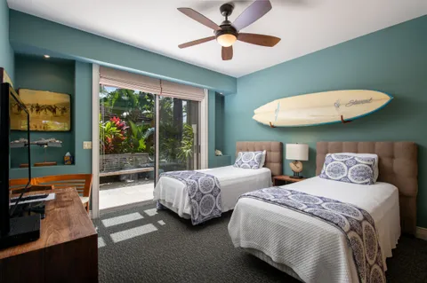 a bedroom with bed and a large window