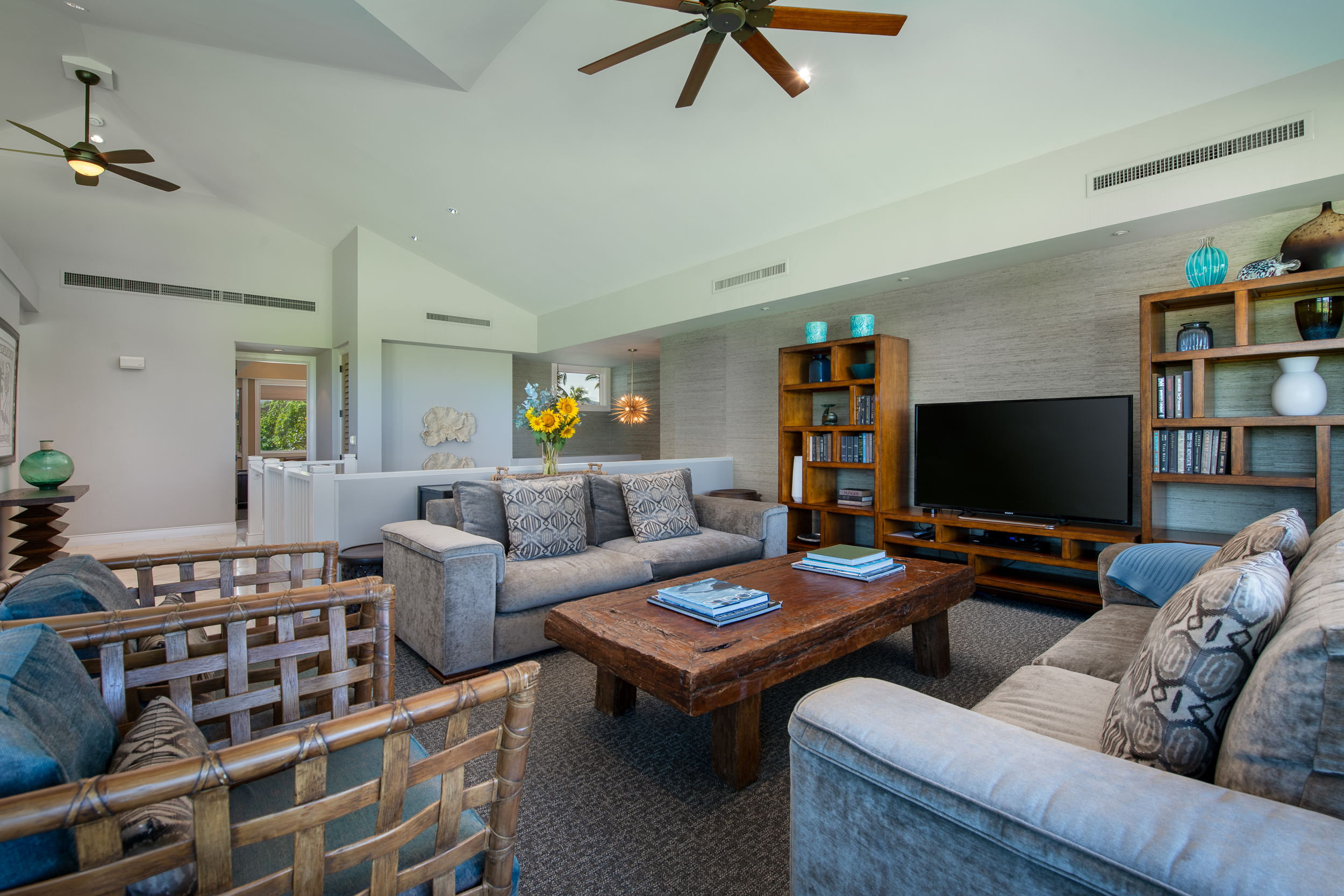 72-140 Waiulu Street, Unit 140B Kailua-Kona, HI 96740 - Photo 5 of 21 a living room with furniture and a flat screen tv