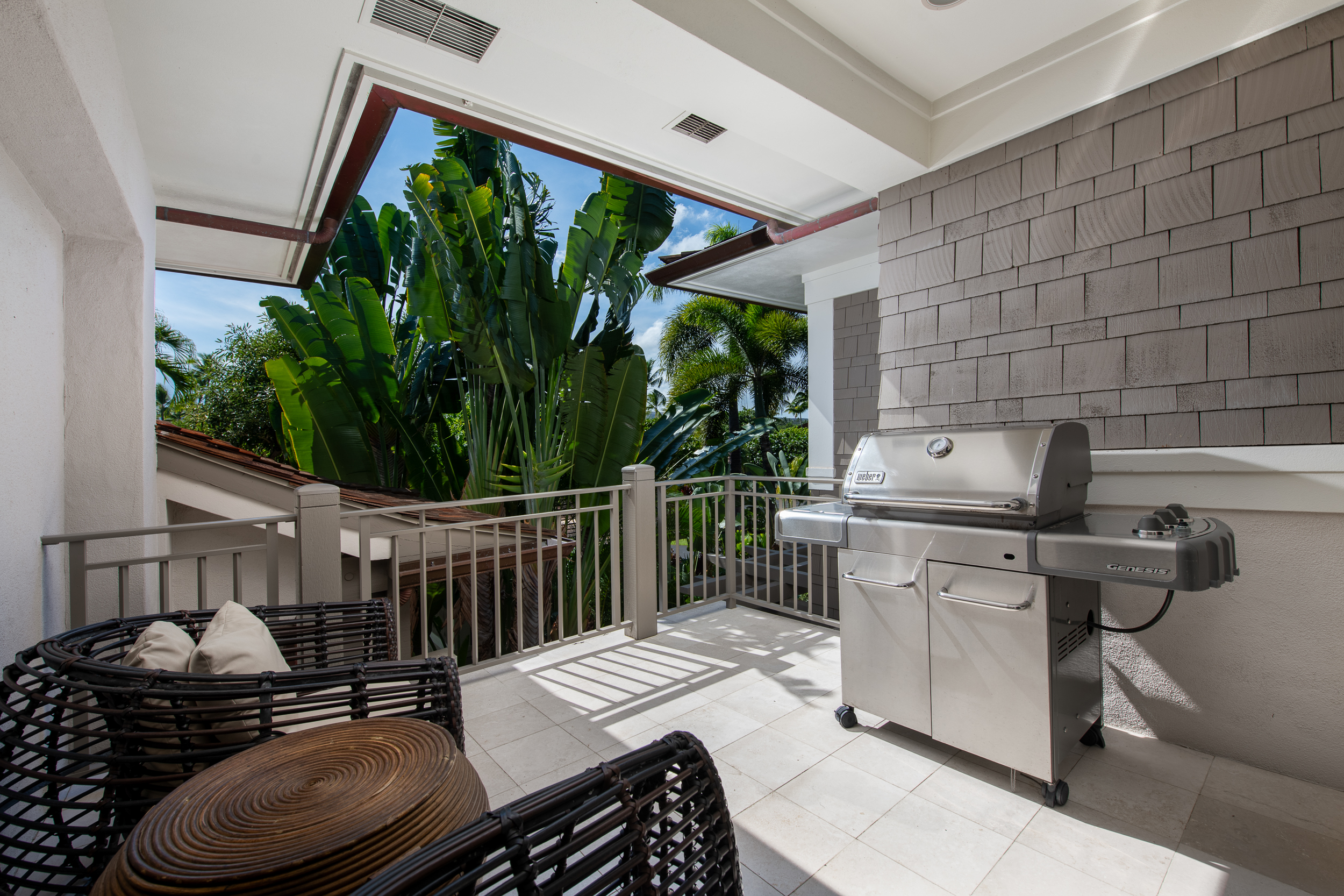 72-140 Waiulu Street, Unit 140B Kailua-Kona, HI 96740 - Photo 10 of 21 a table and chairs sitting in front of a house