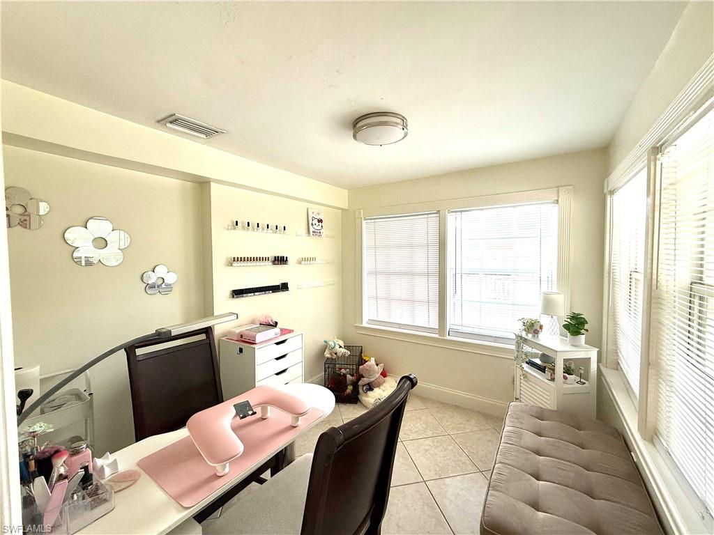 1964 42nd Street Southwest Naples, FL 34116 - Photo 17 of 25 a living room with furniture and a large window