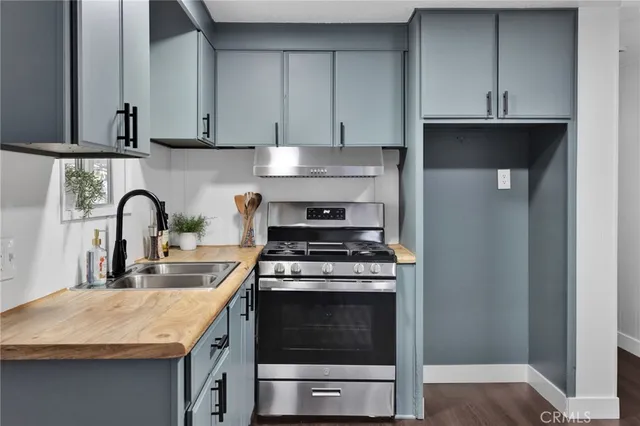 a kitchen with granite countertop a stove and a sink
