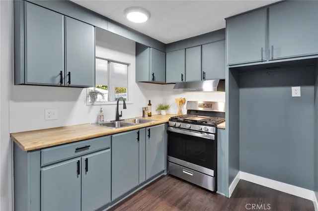 a kitchen with sink cabinets and stainless steel appliances