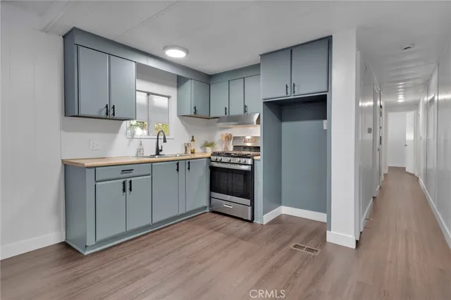 a kitchen with a sink a window and cabinets