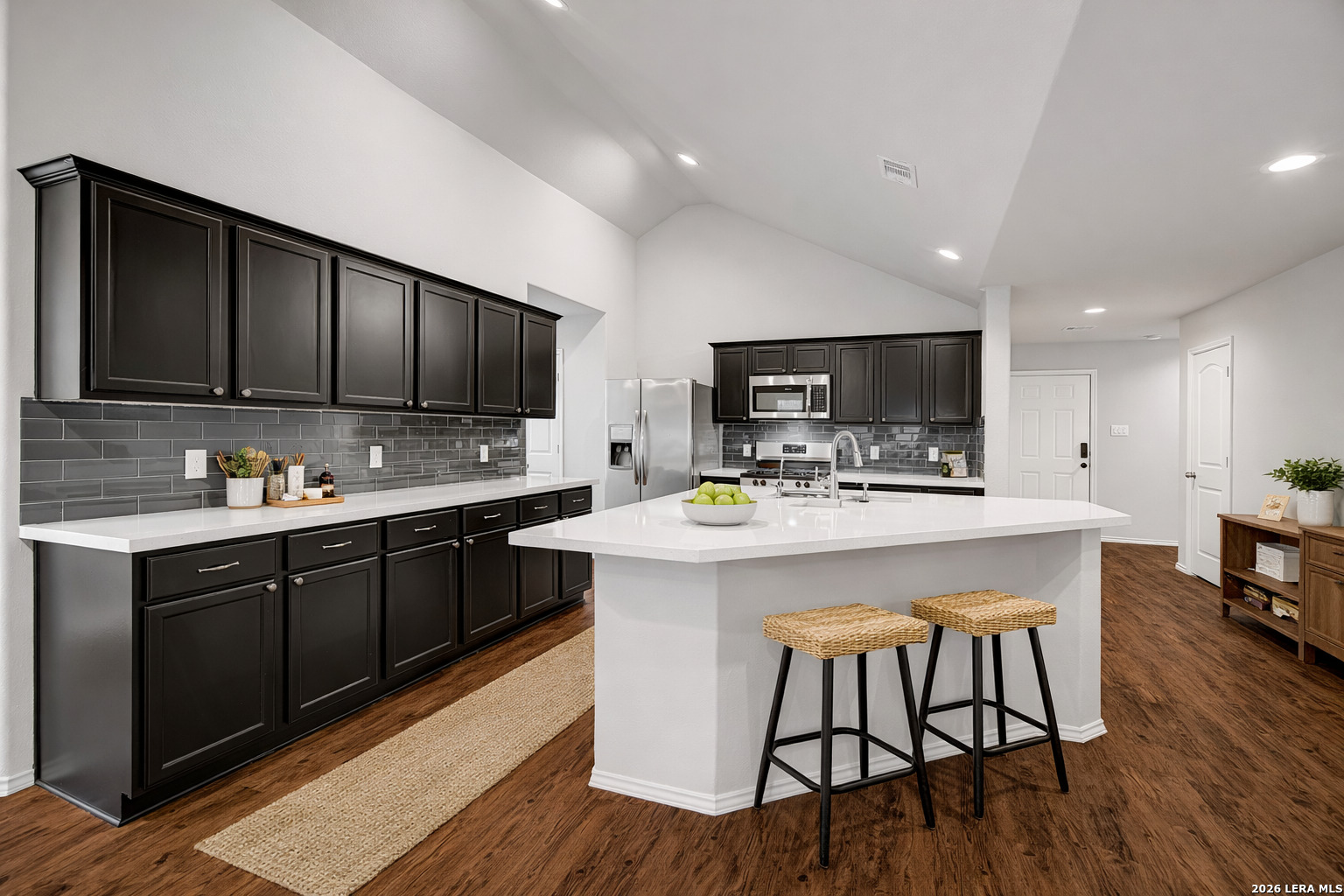 5627 Mesquite Oaks Trail Spring, TX 77389 - Photo 1 of 1 a kitchen with kitchen island a cabinets wooden floor and a dining table