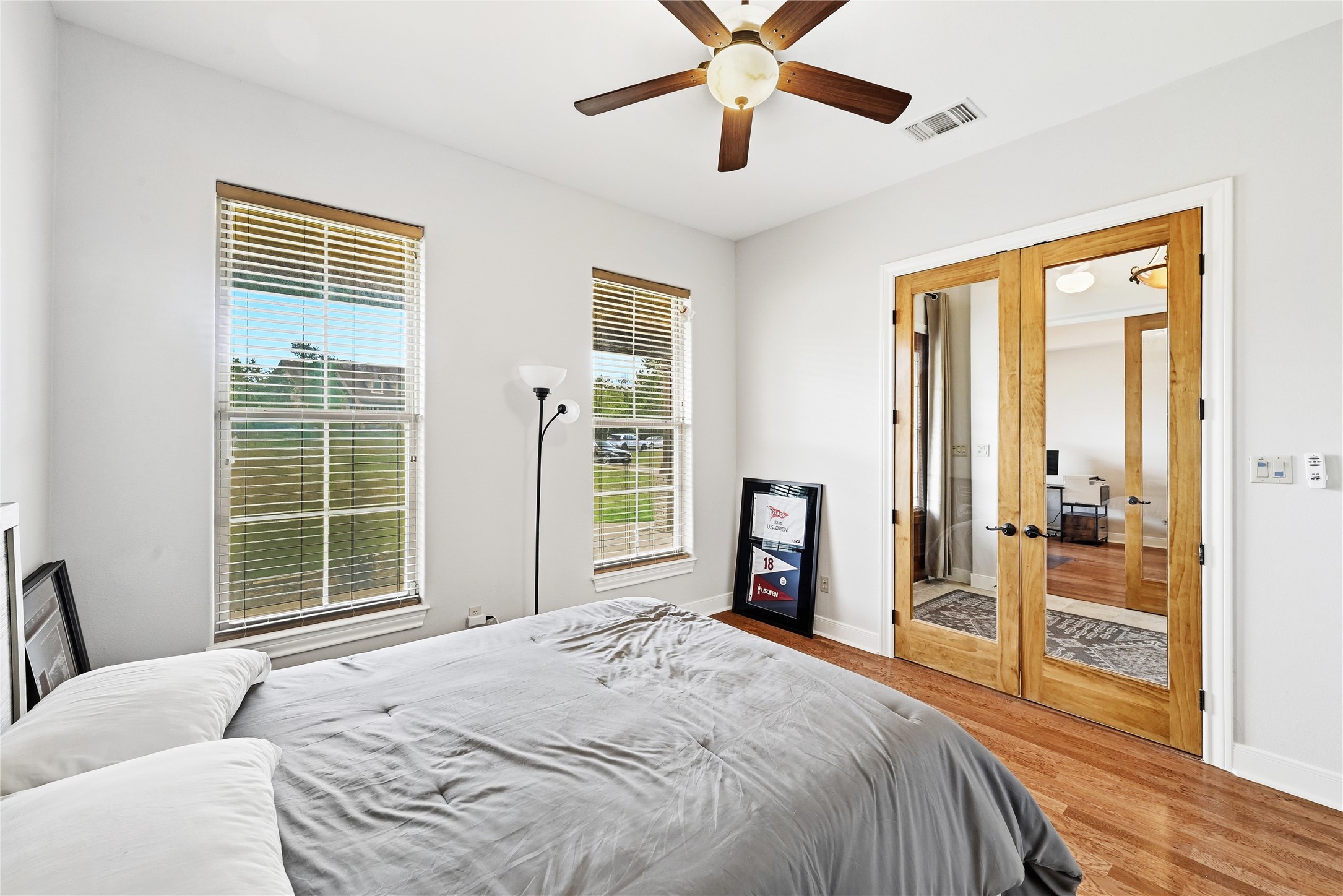 140 Winchester Road Bastrop, TX 78602 - Photo 25 of 36 Spare Bedroom 1 featuring french doors, wood finished floors, multiple windows, and a ceiling fan