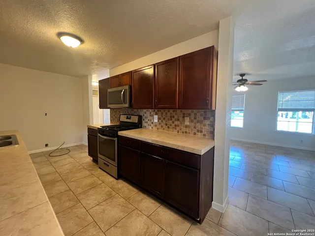a kitchen with stainless steel appliances granite countertop a stove and a sink