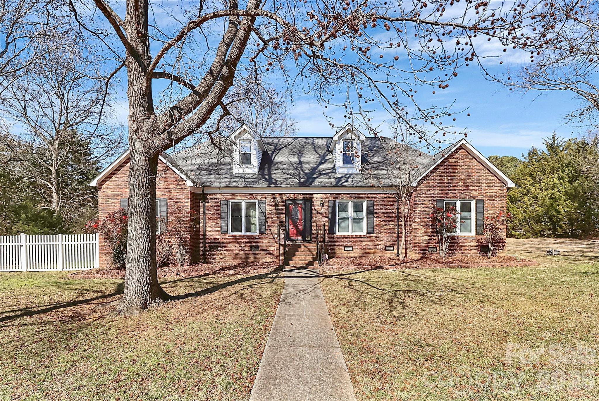 a view of a house with large trees