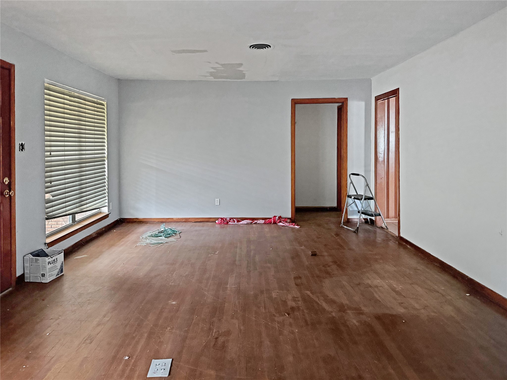 17419 Bamwood Road Houston, TX 77090 - Photo 7 of 12 an empty room with wooden floor and windows