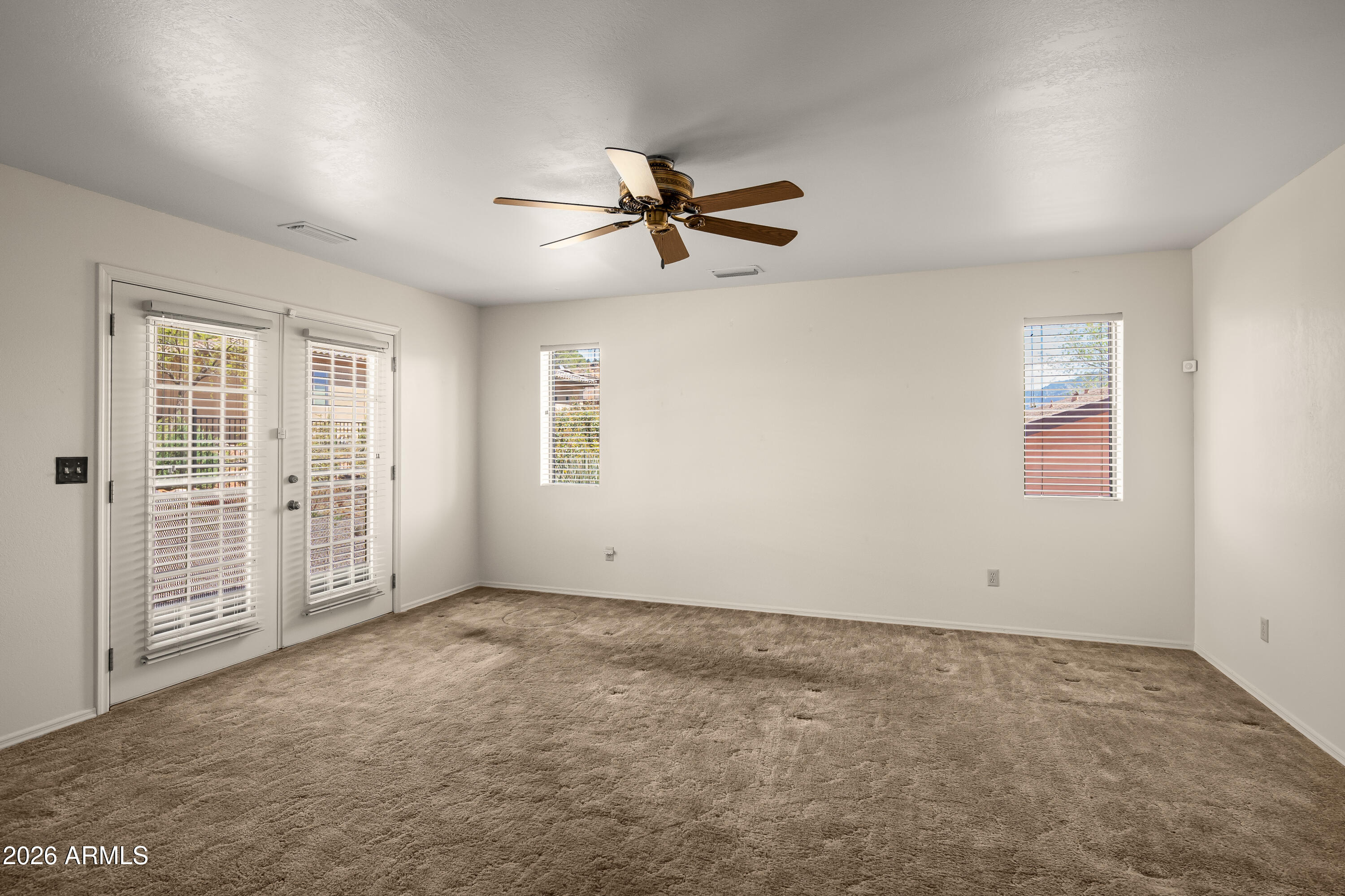2320 Buckboard Road Sedona, AZ 86336 - Photo 12 of 19 an empty room with windows and fan