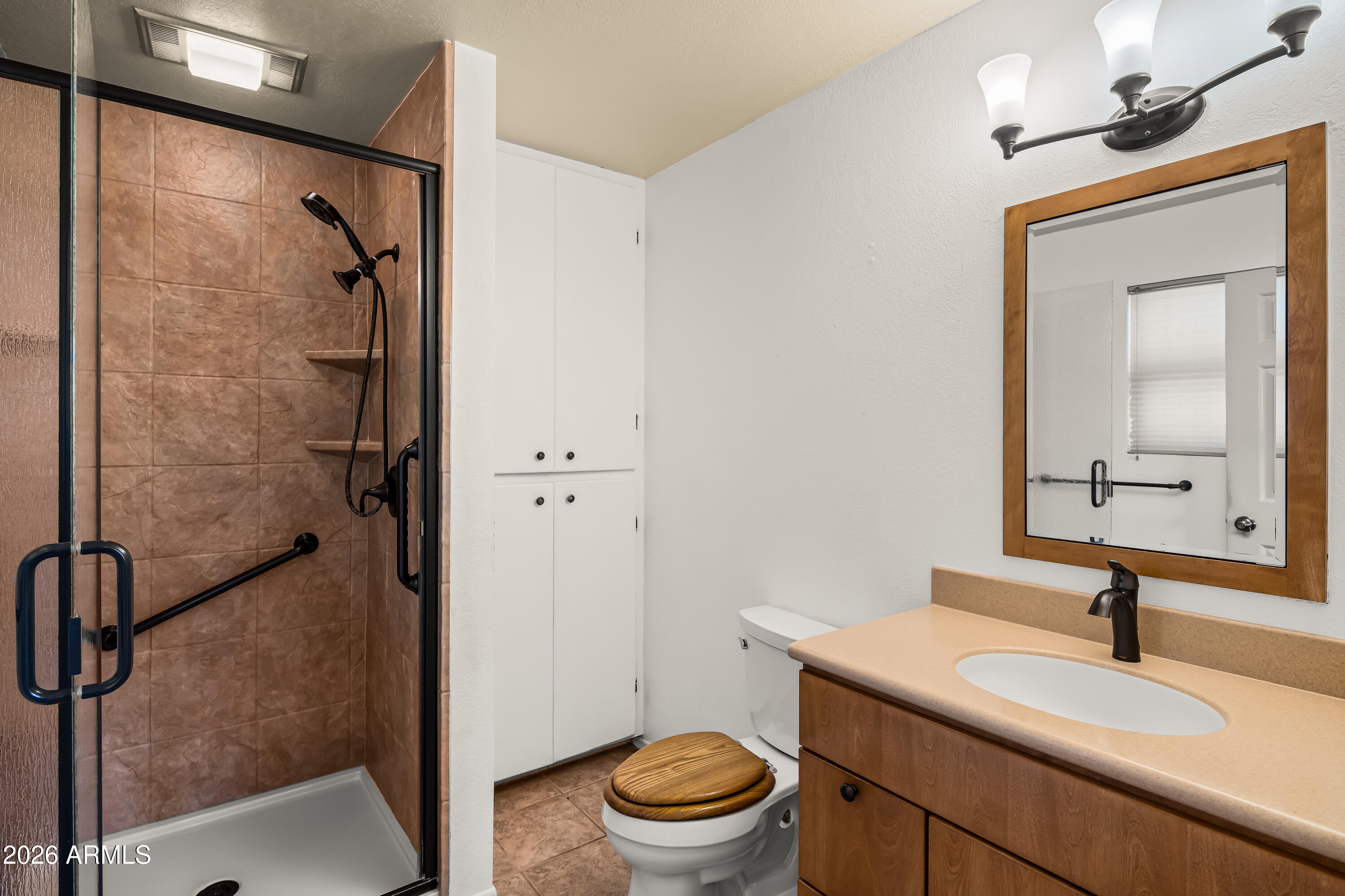 2320 Buckboard Road Sedona, AZ 86336 - Photo 14 of 19 a bathroom with a granite countertop sink toilet a mirror and shower