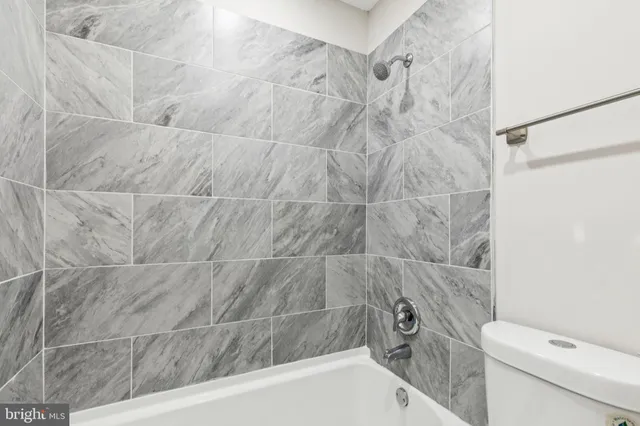 a bathroom with a bathtub and a toilet