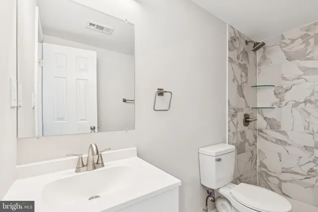 a white toilet sitting next to a shower curtain