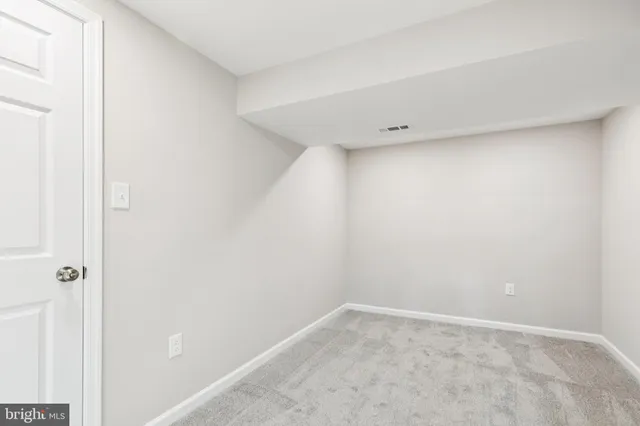 a big room with wooden floor and windows