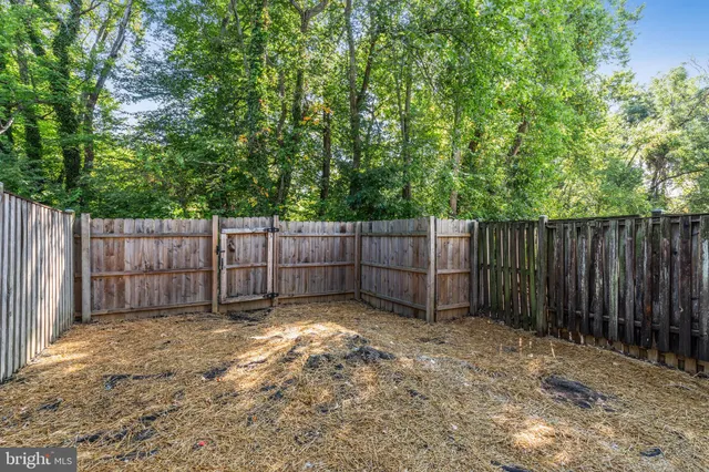 a view of a fence in the backyard