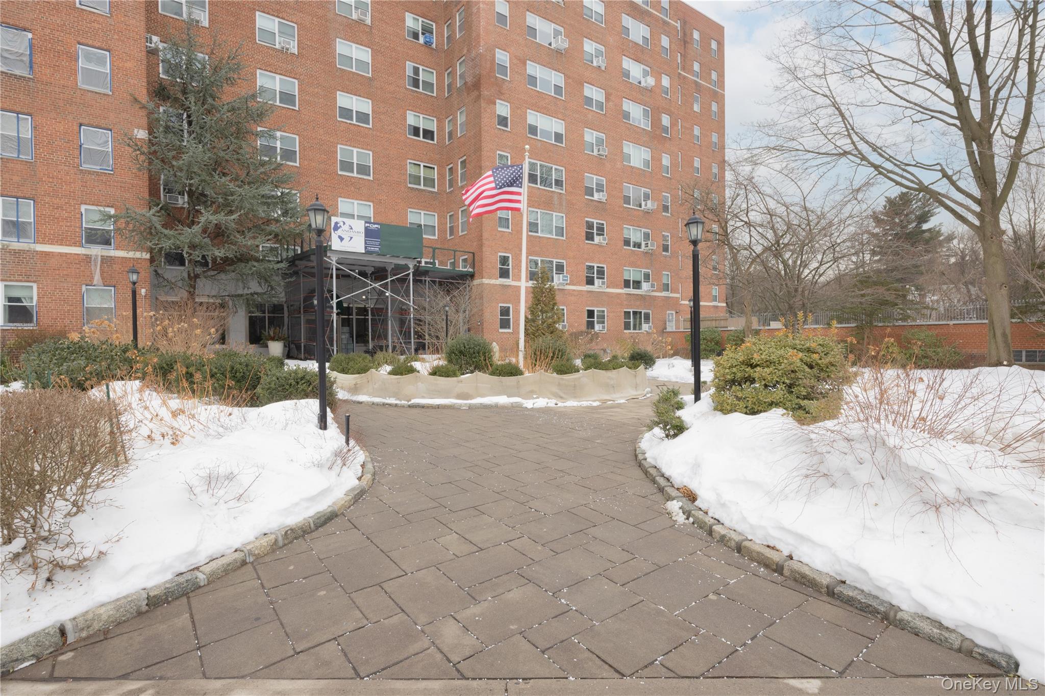 900 Palmer Road, Unit 9J Bronxville, NY 10708 - Photo 12 of 14 a view of a building with snow on the road