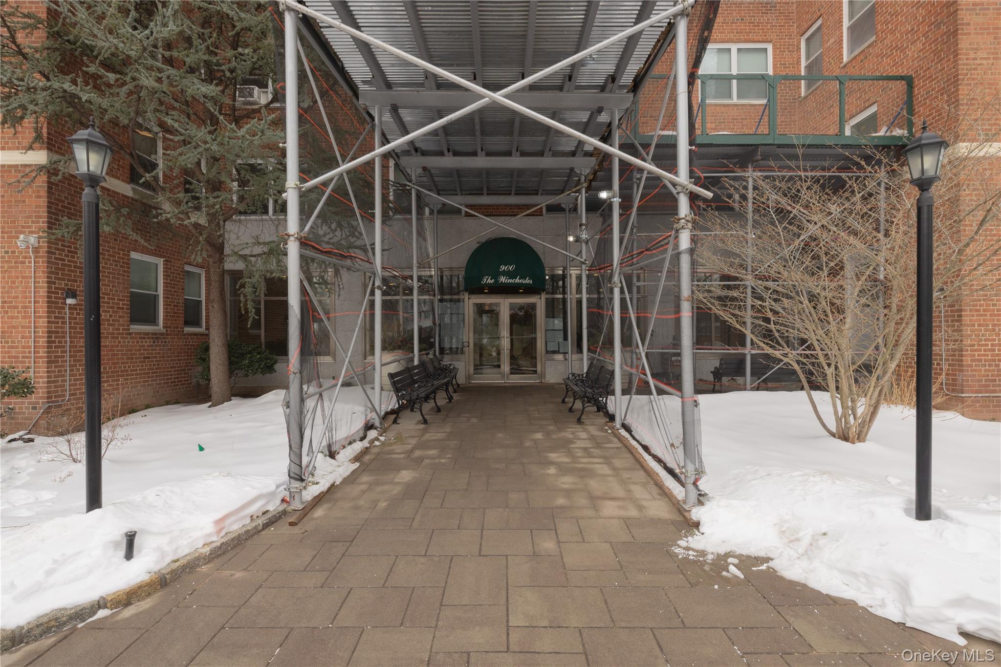 900 Palmer Road, Unit 9J Bronxville, NY 10708 - Photo 13 of 14 a view of a house with a wooden bench