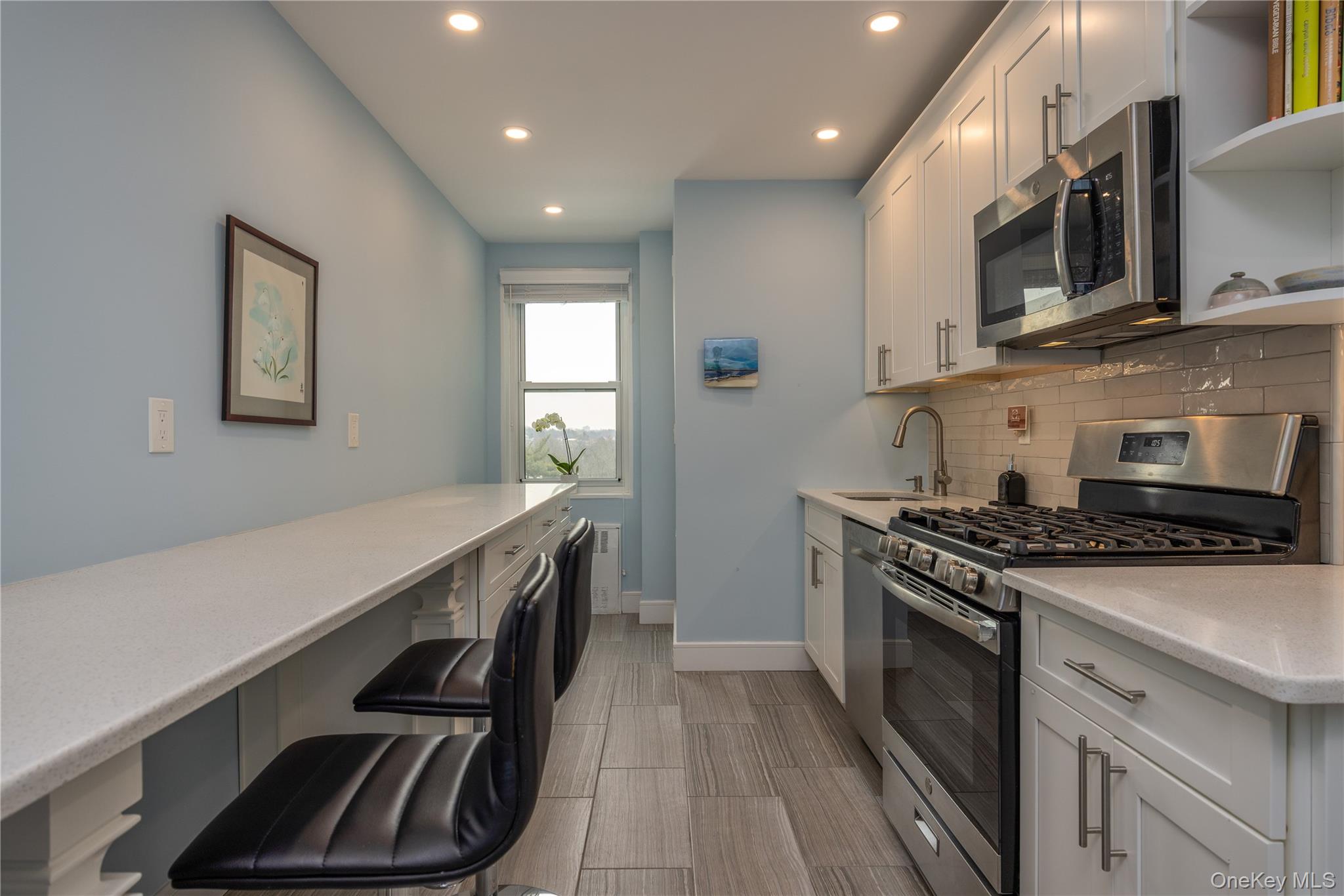900 Palmer Road, Unit 9J Bronxville, NY 10708 - Photo 2 of 14 a kitchen with stainless steel appliances a stove sink and cabinets