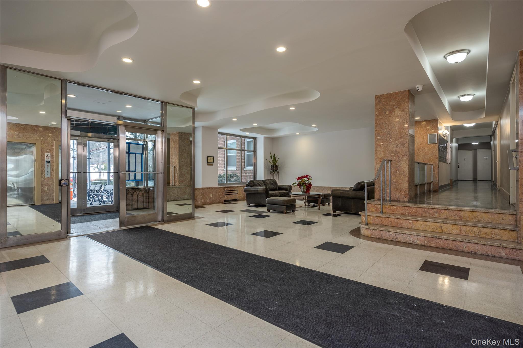 900 Palmer Road, Unit 9J Bronxville, NY 10708 - Photo 10 of 14 a large room with lots of counter space and glass door