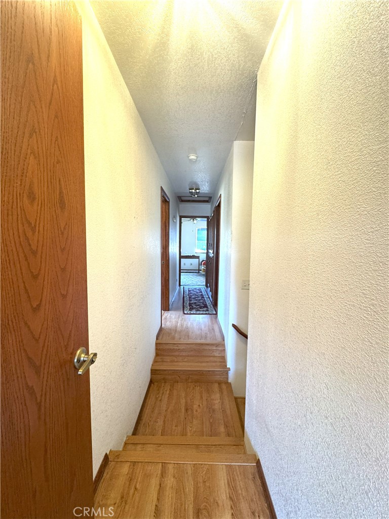 18720 Wingfoot Place Tehachapi, CA 93561 - Photo 11 of 26 a view of a hallway with wooden floor and glass doors
