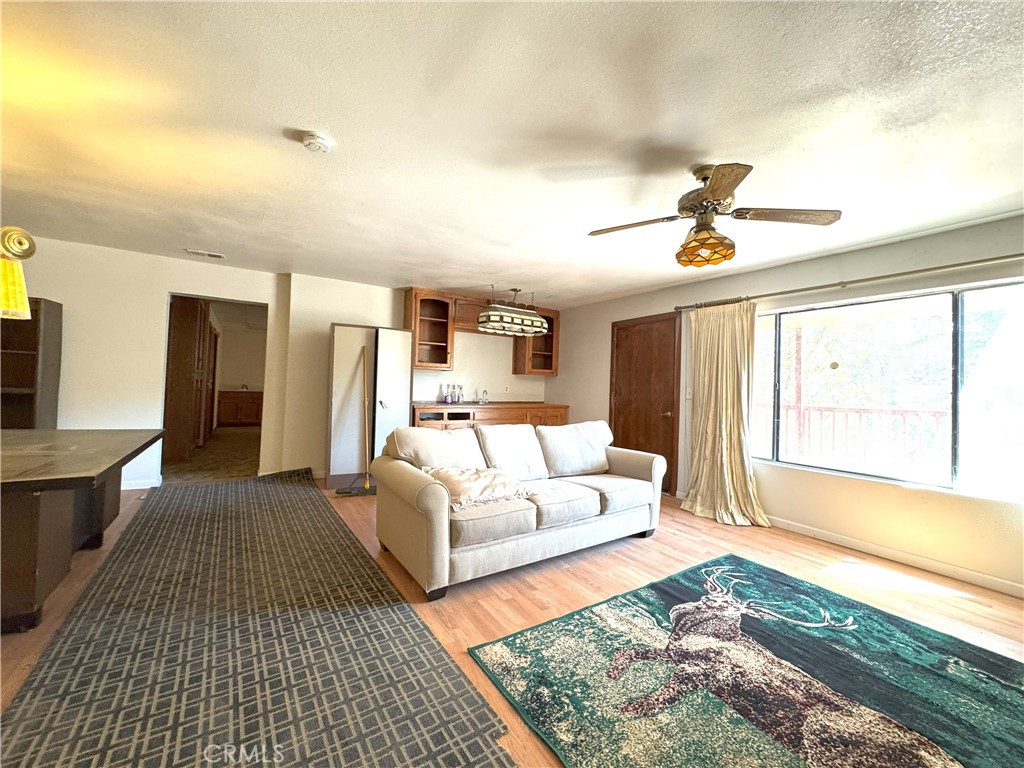 18720 Wingfoot Place Tehachapi, CA 93561 - Photo 7 of 26 a living room with a couch and wooden floor