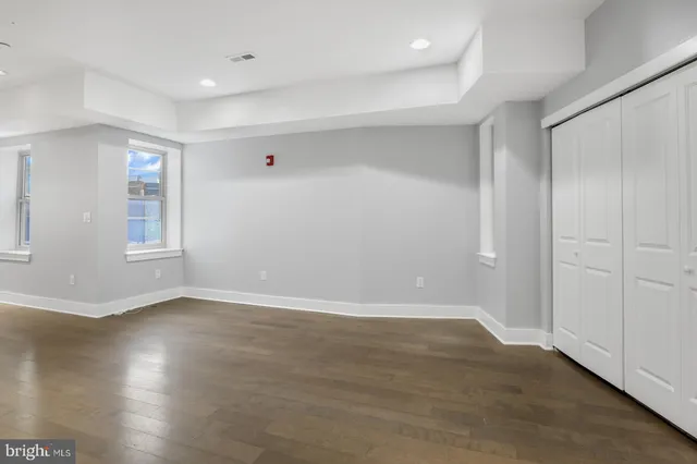 a view of an empty room with wooden floor