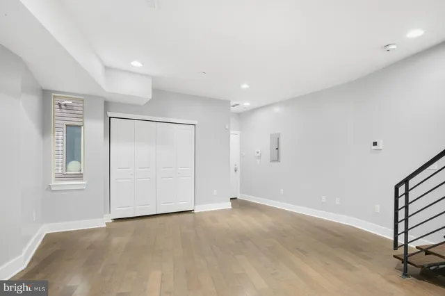 a kitchen with stainless steel appliances granite countertop a refrigerator sink and wooden floor
