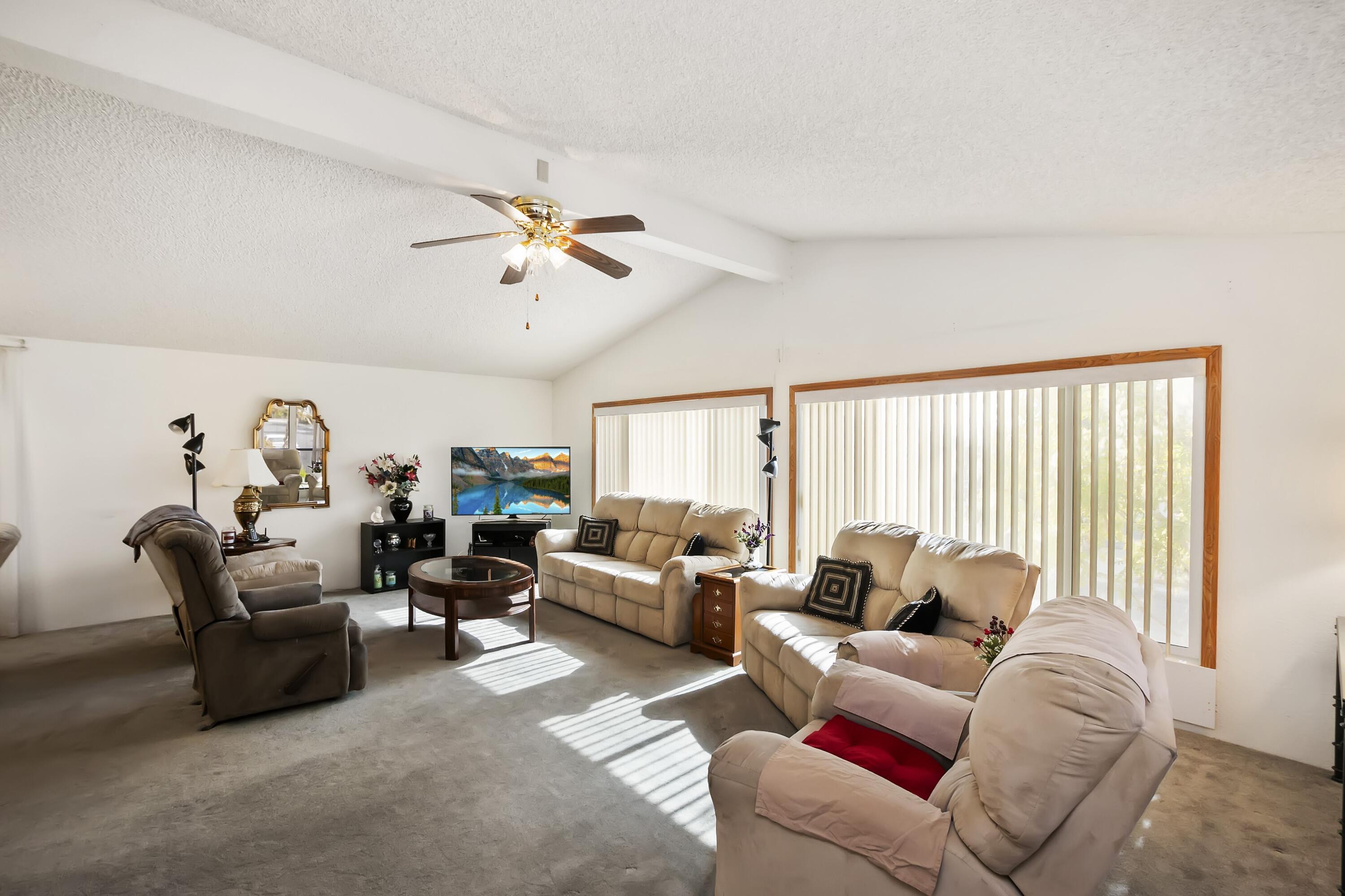 74711 Dillon Road, Unit 585 Desert Hot Springs, CA 92241 - Photo 14 of 60 a living room with furniture ceiling fan and a window