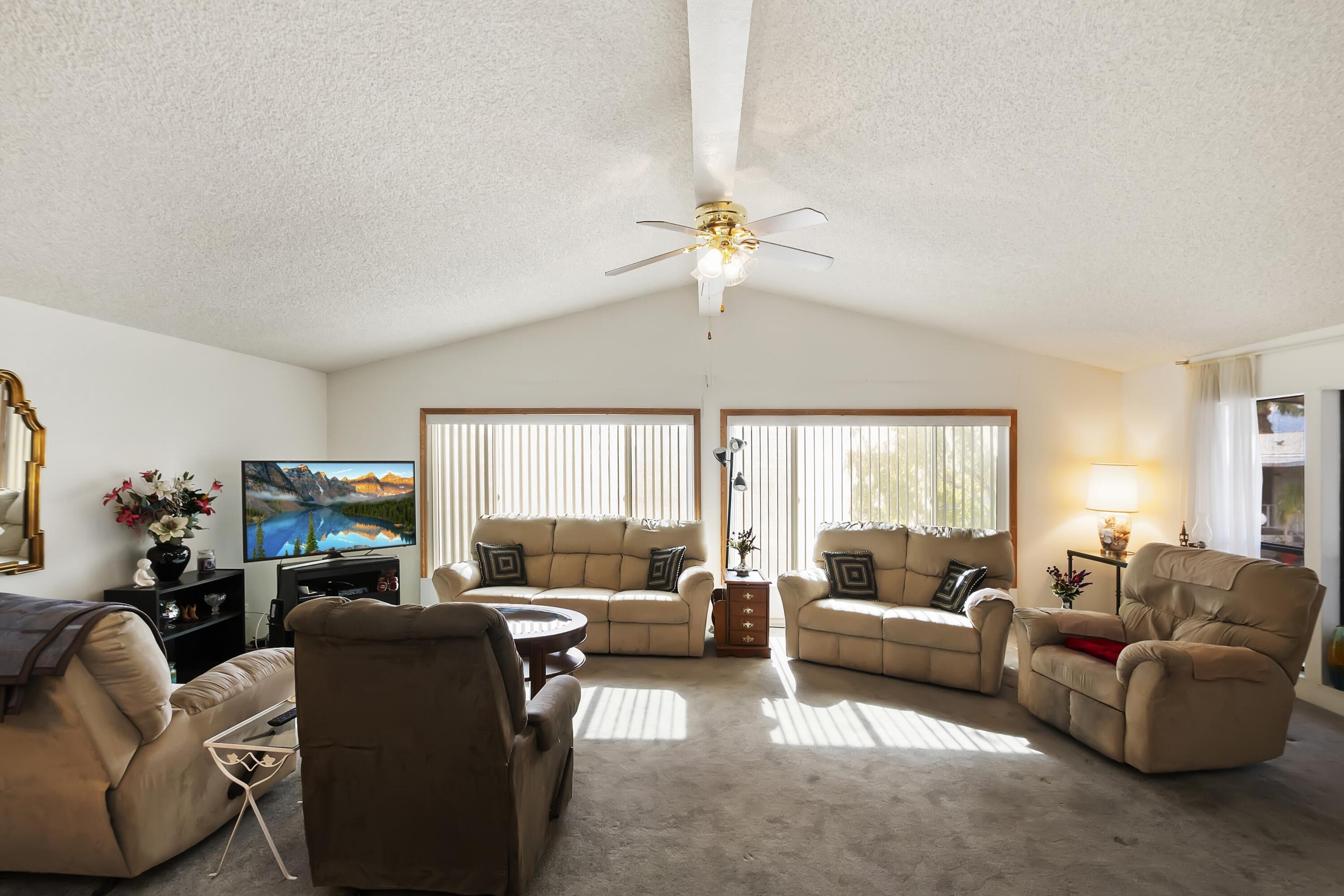 74711 Dillon Road, Unit 585 Desert Hot Springs, CA 92241 - Photo 16 of 60 a living room with furniture ceiling fan and a window