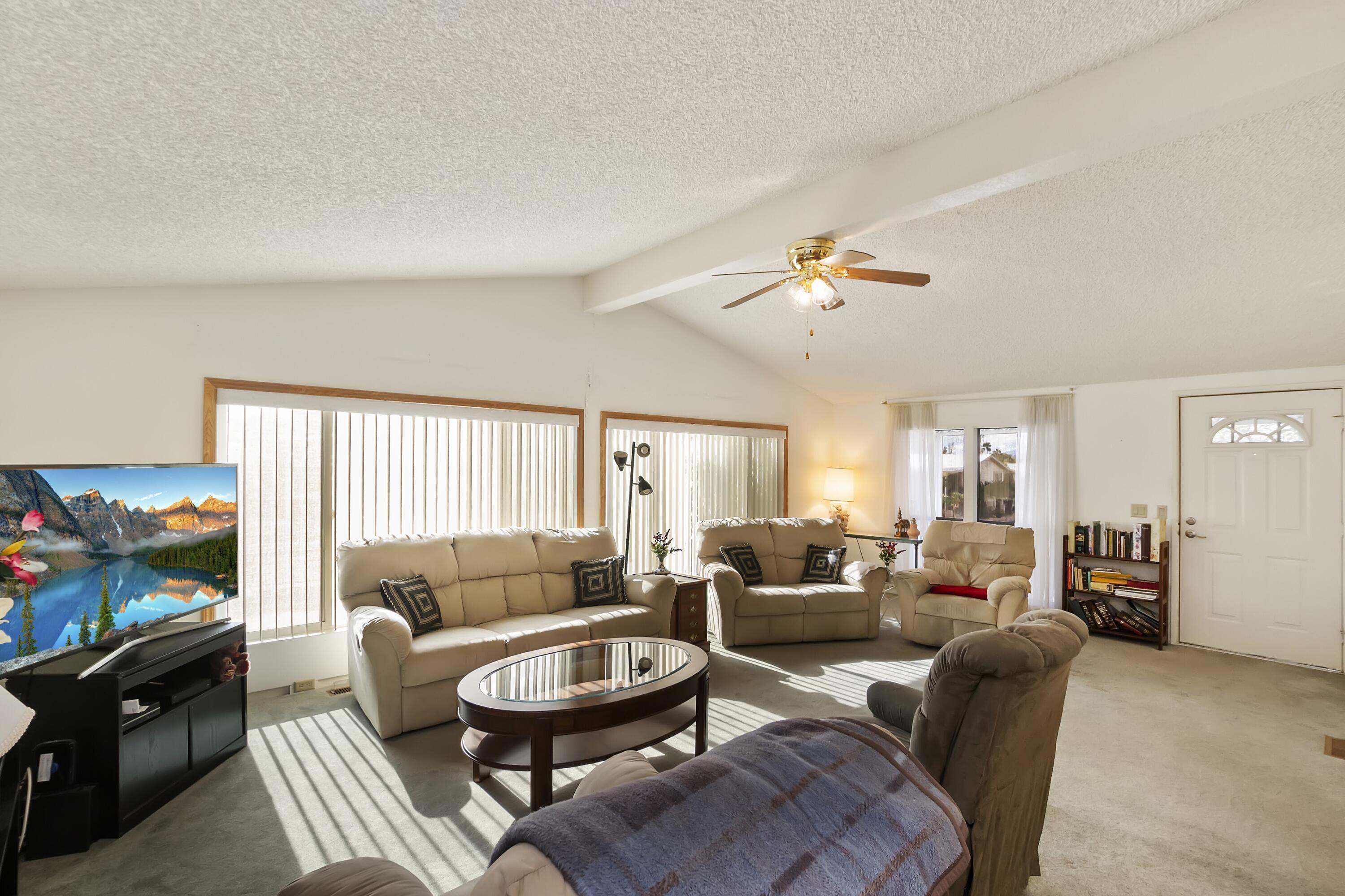74711 Dillon Road, Unit 585 Desert Hot Springs, CA 92241 - Photo 17 of 60 a living room with furniture a ceiling fan and a window