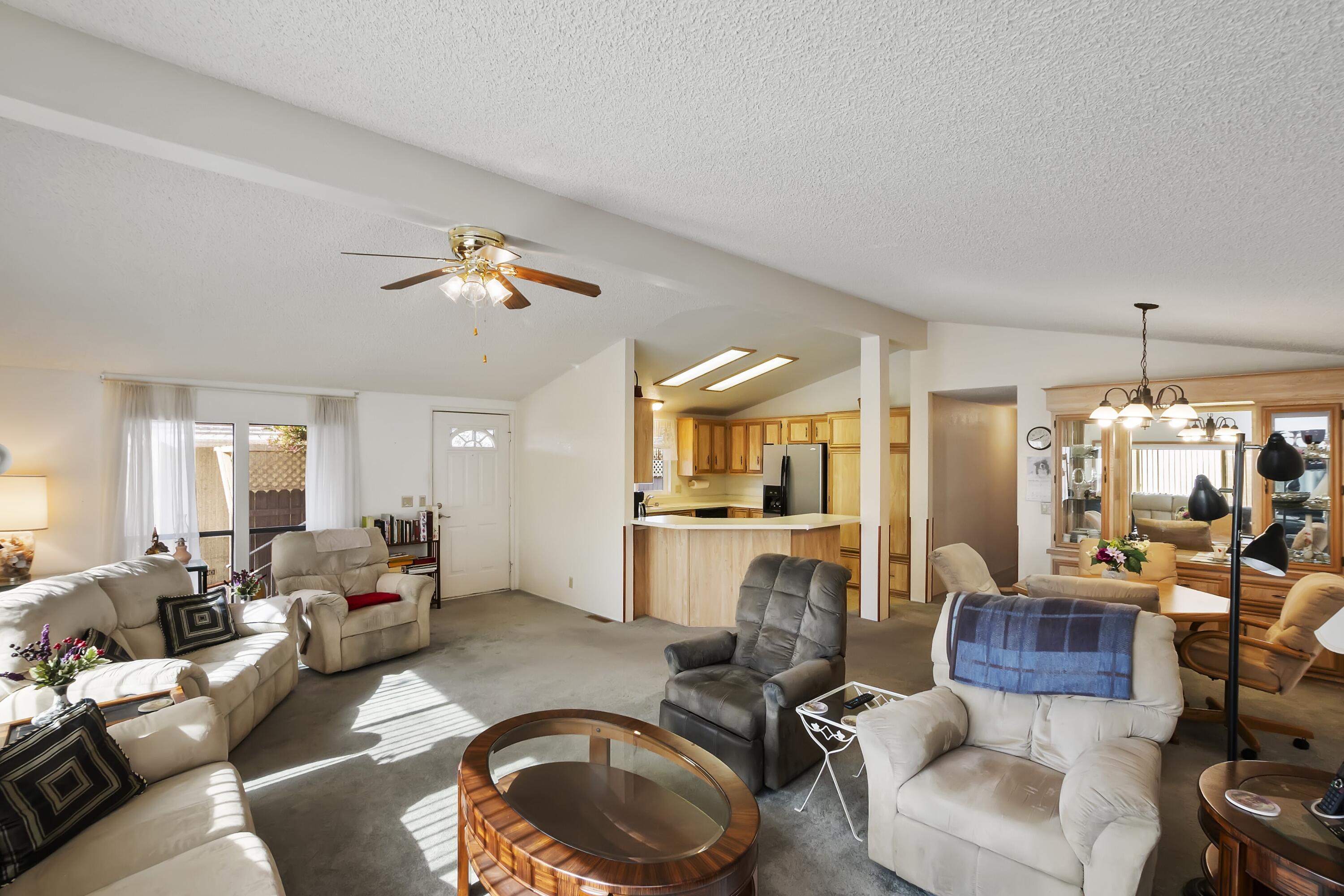 74711 Dillon Road, Unit 585 Desert Hot Springs, CA 92241 - Photo 18 of 60 a living room with furniture and a chandelier