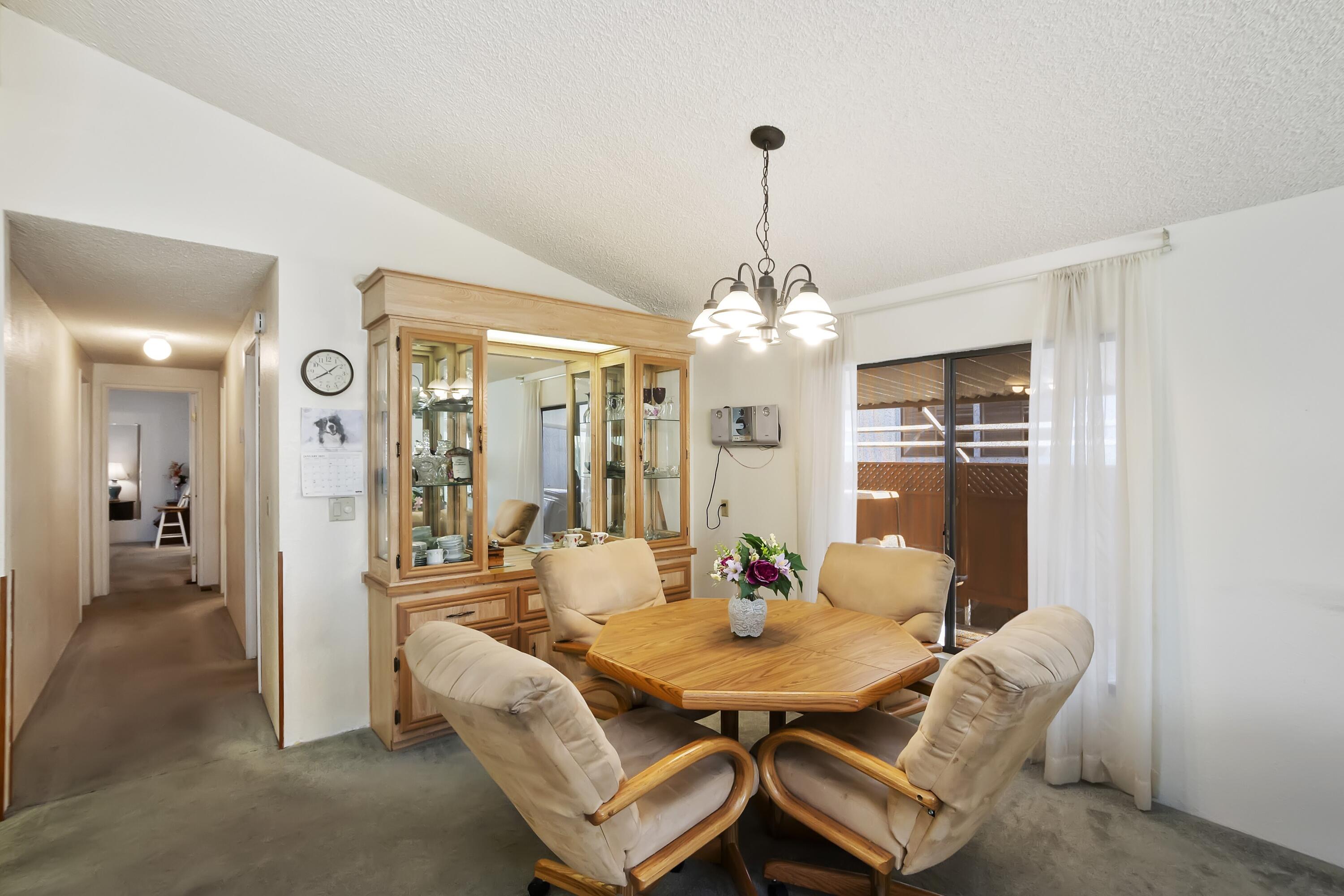 74711 Dillon Road, Unit 585 Desert Hot Springs, CA 92241 - Photo 19 of 60 a view of a dining room with furniture and chandelier