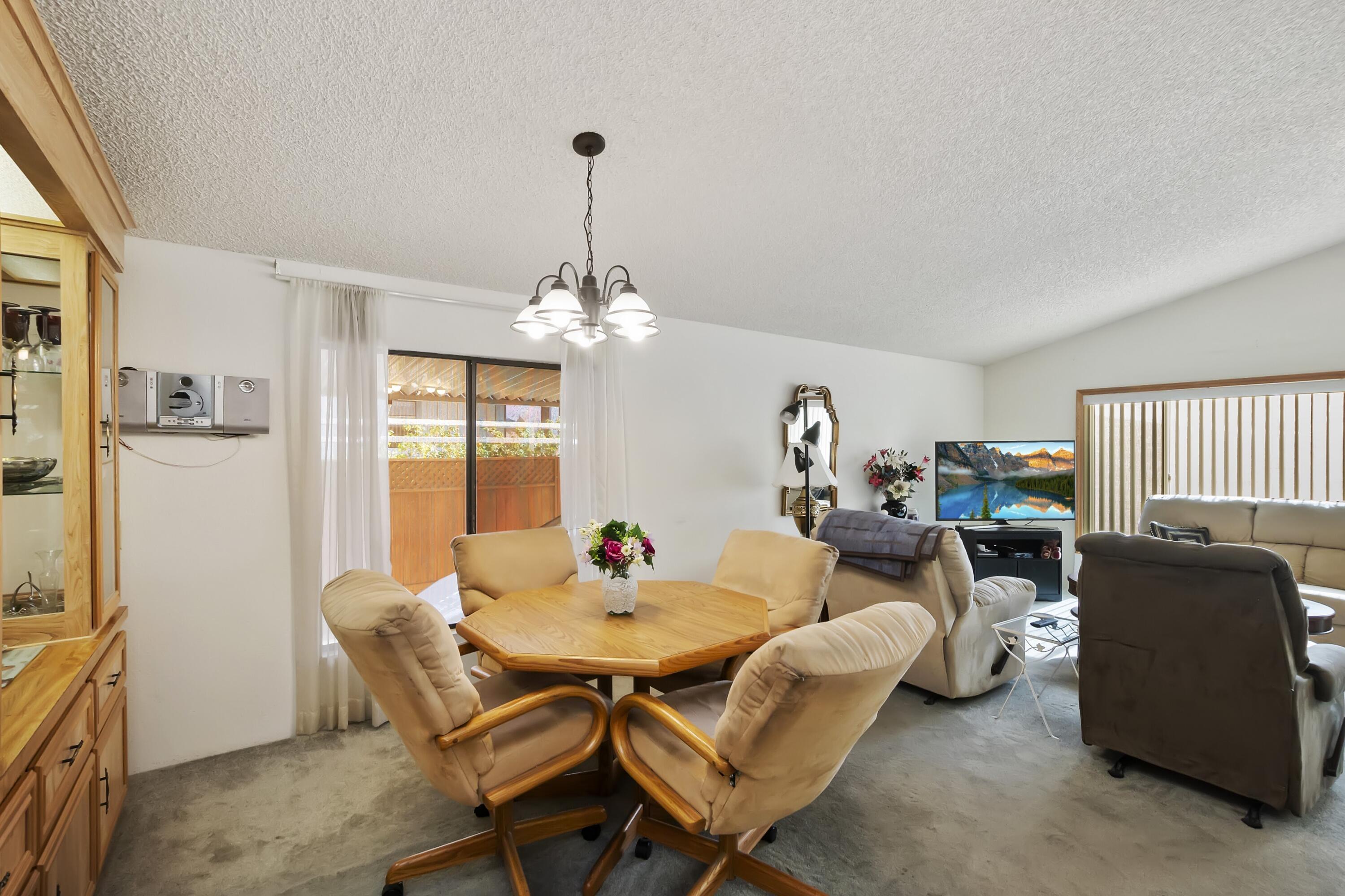 74711 Dillon Road, Unit 585 Desert Hot Springs, CA 92241 - Photo 21 of 60 a view of a dining room with furniture and chandelier