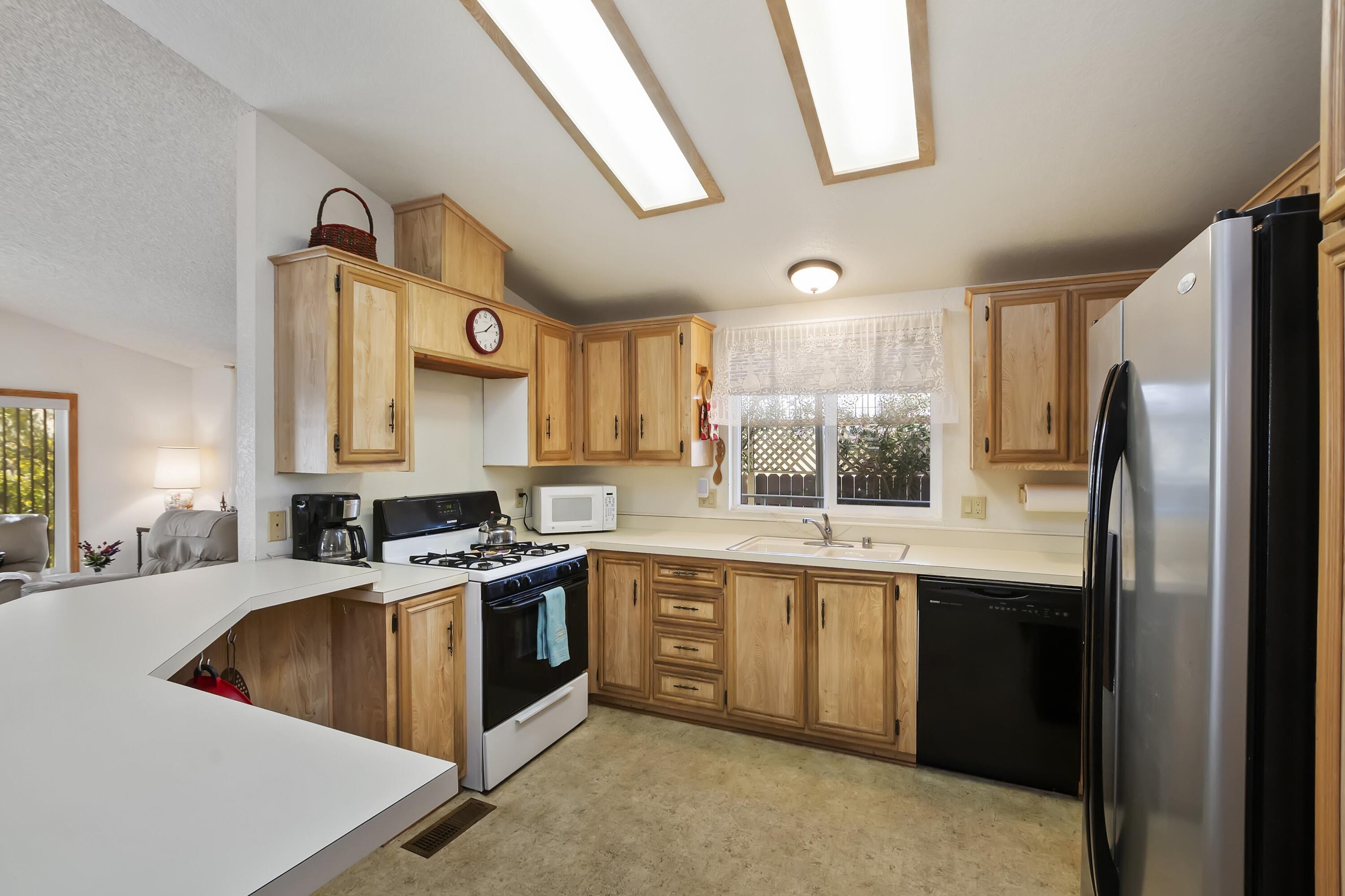 74711 Dillon Road, Unit 585 Desert Hot Springs, CA 92241 - Photo 23 of 60 a kitchen with stainless steel appliances granite countertop a sink stove and refrigerator