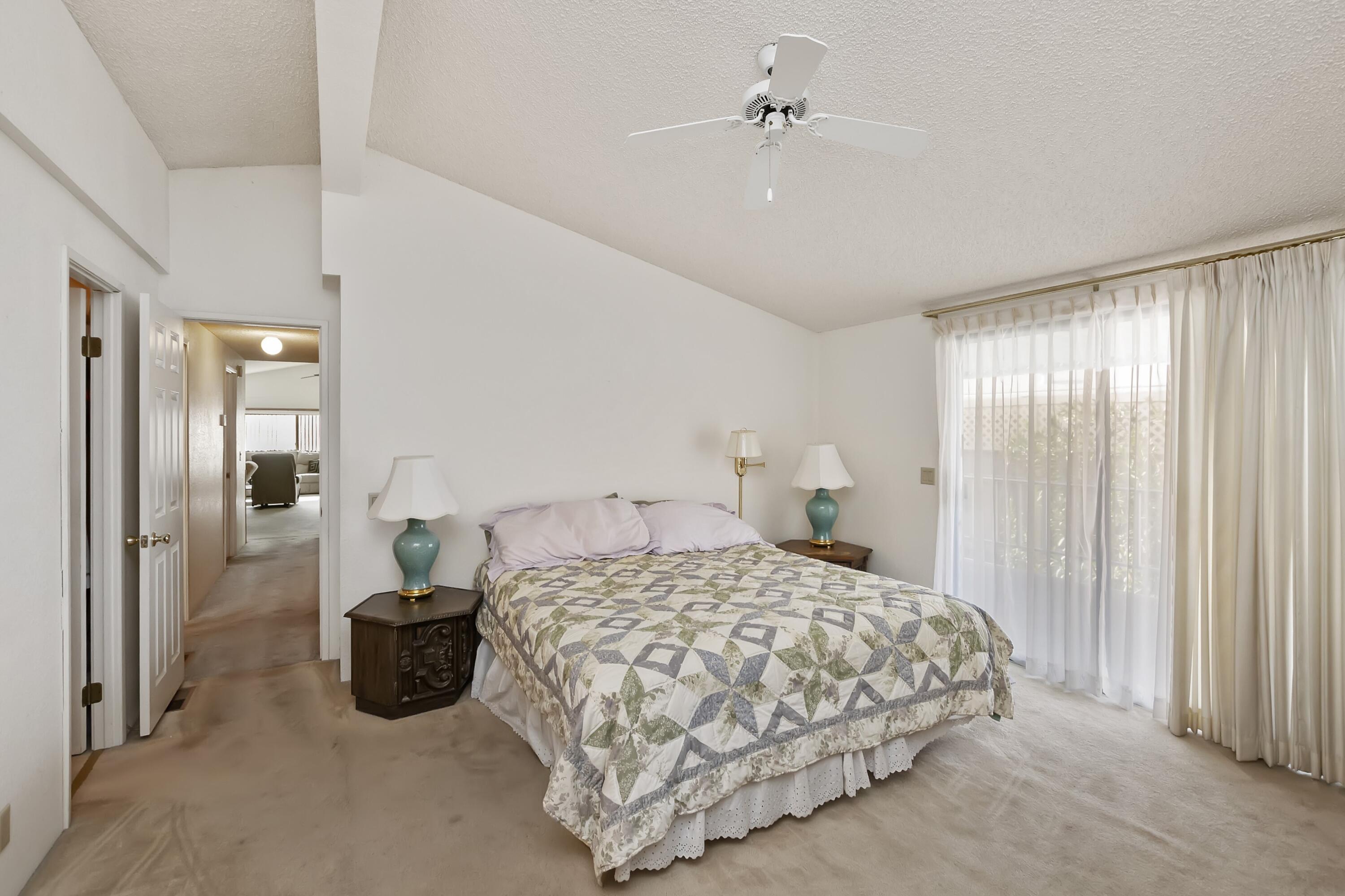 74711 Dillon Road, Unit 585 Desert Hot Springs, CA 92241 - Photo 28 of 60 a bedroom with a bed and a chandelier