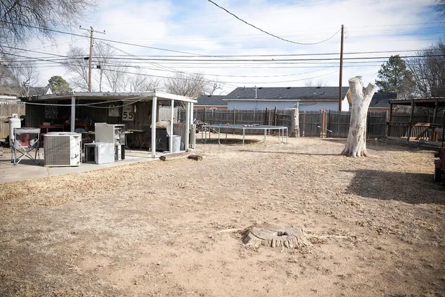 a backyard of a house with shaded area