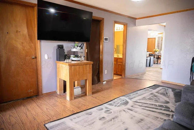 a living room with a couch and a table with wooden floor