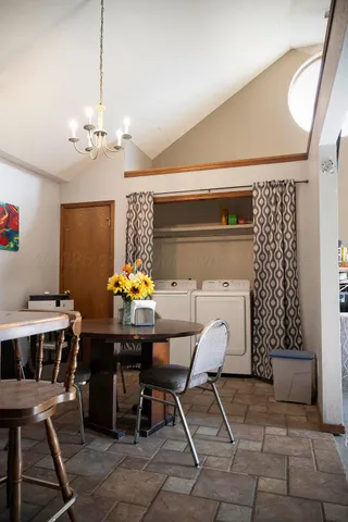 a view of a dining room with furniture and chandelier
