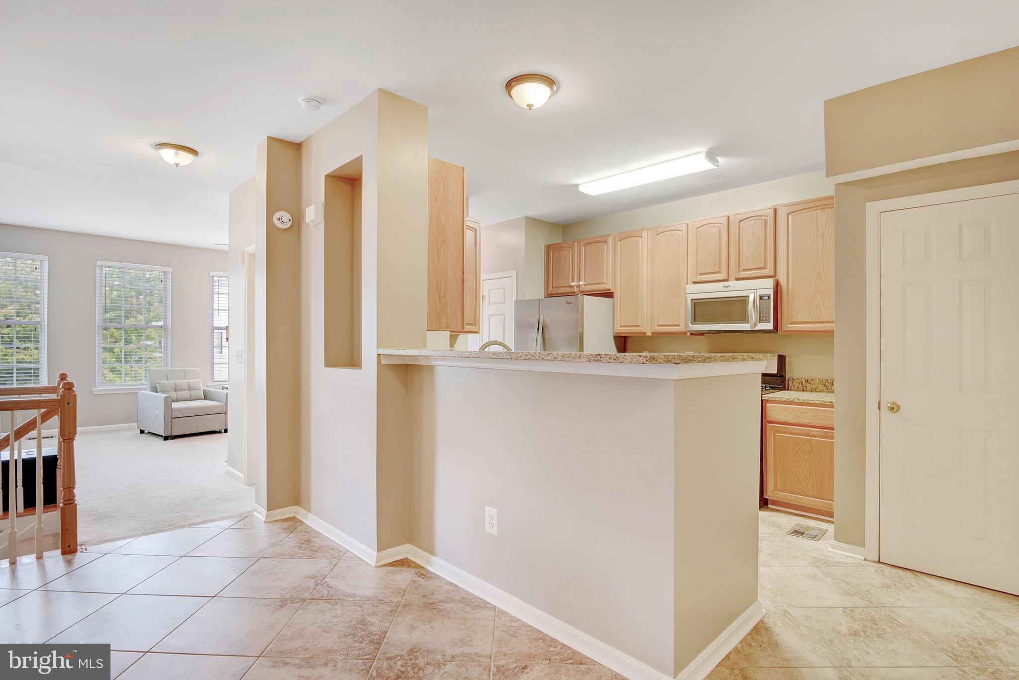 13017 Bath Gate Way Bristow, VA 20136 - Photo 11 of 35 a kitchen with stainless steel appliances a refrigerator sink and cabinets