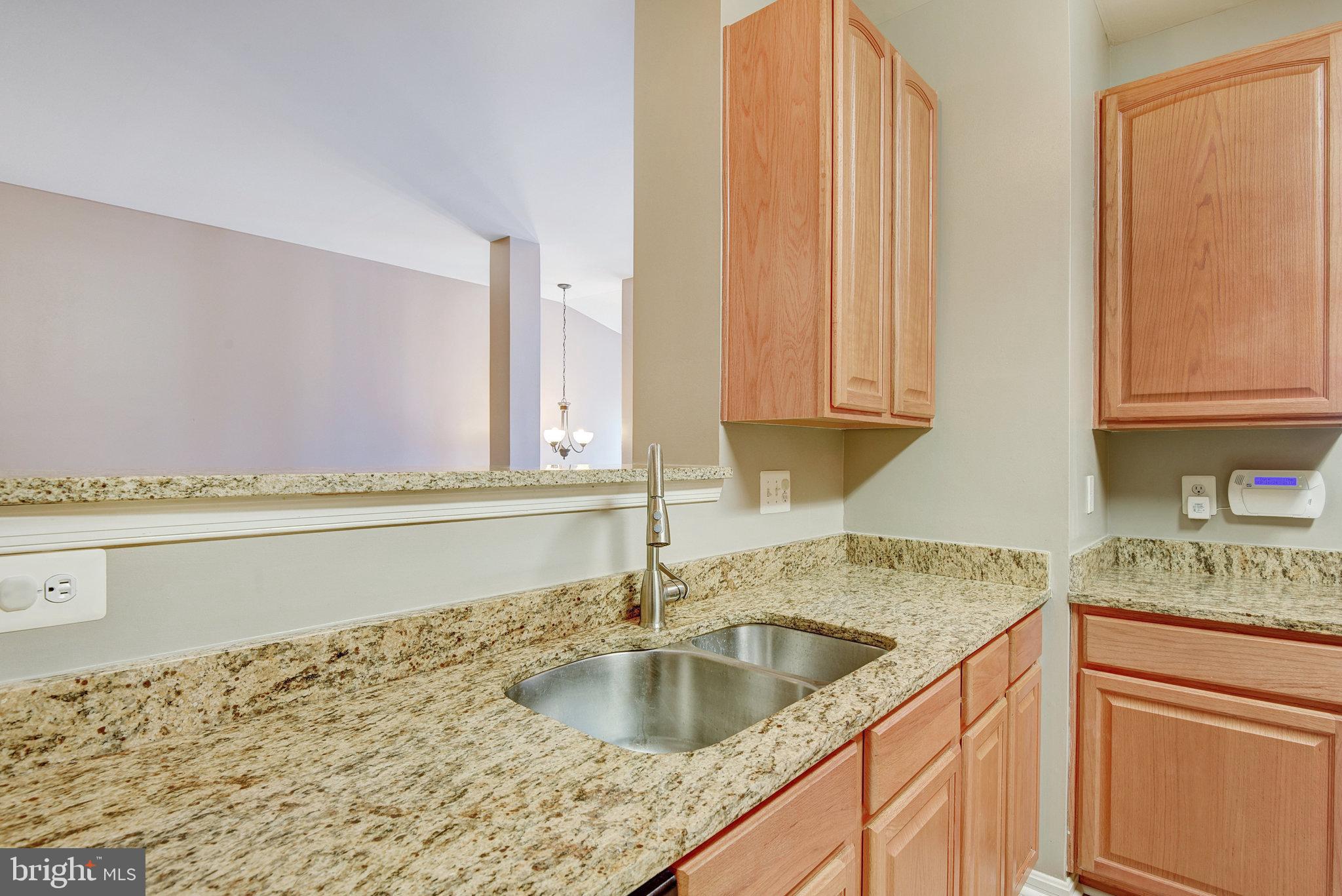13017 Bath Gate Way Bristow, VA 20136 - Photo 14 of 35 a kitchen with granite countertop a sink and a stove