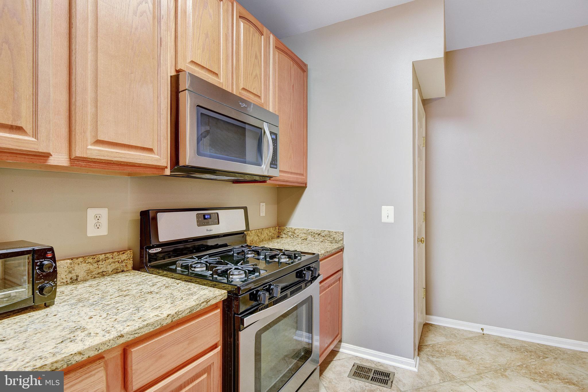 13017 Bath Gate Way Bristow, VA 20136 - Photo 15 of 35 a kitchen with a stove and a microwave
