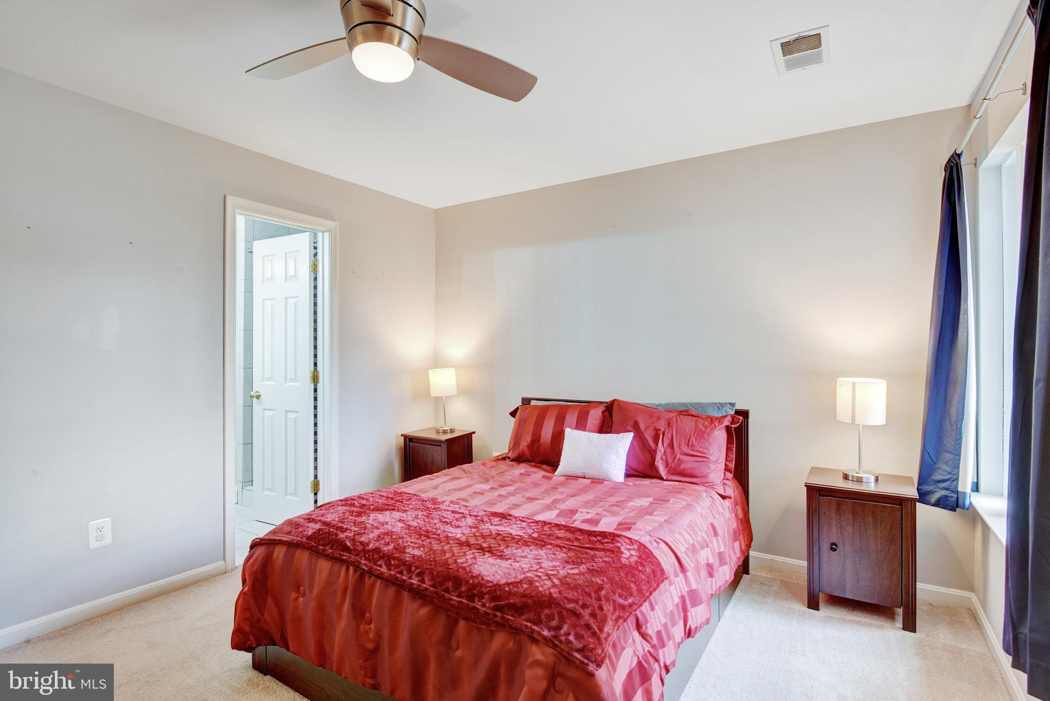 13017 Bath Gate Way Bristow, VA 20136 - Photo 19 of 35 a bedroom with a bed and a chandelier