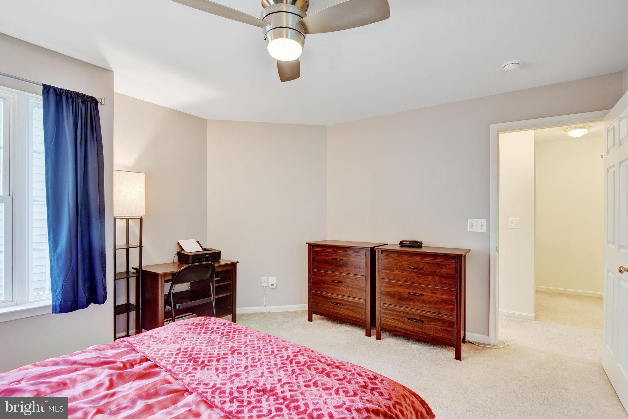 13017 Bath Gate Way Bristow, VA 20136 - Photo 20 of 35 a bedroom with a dresser and a chandelier