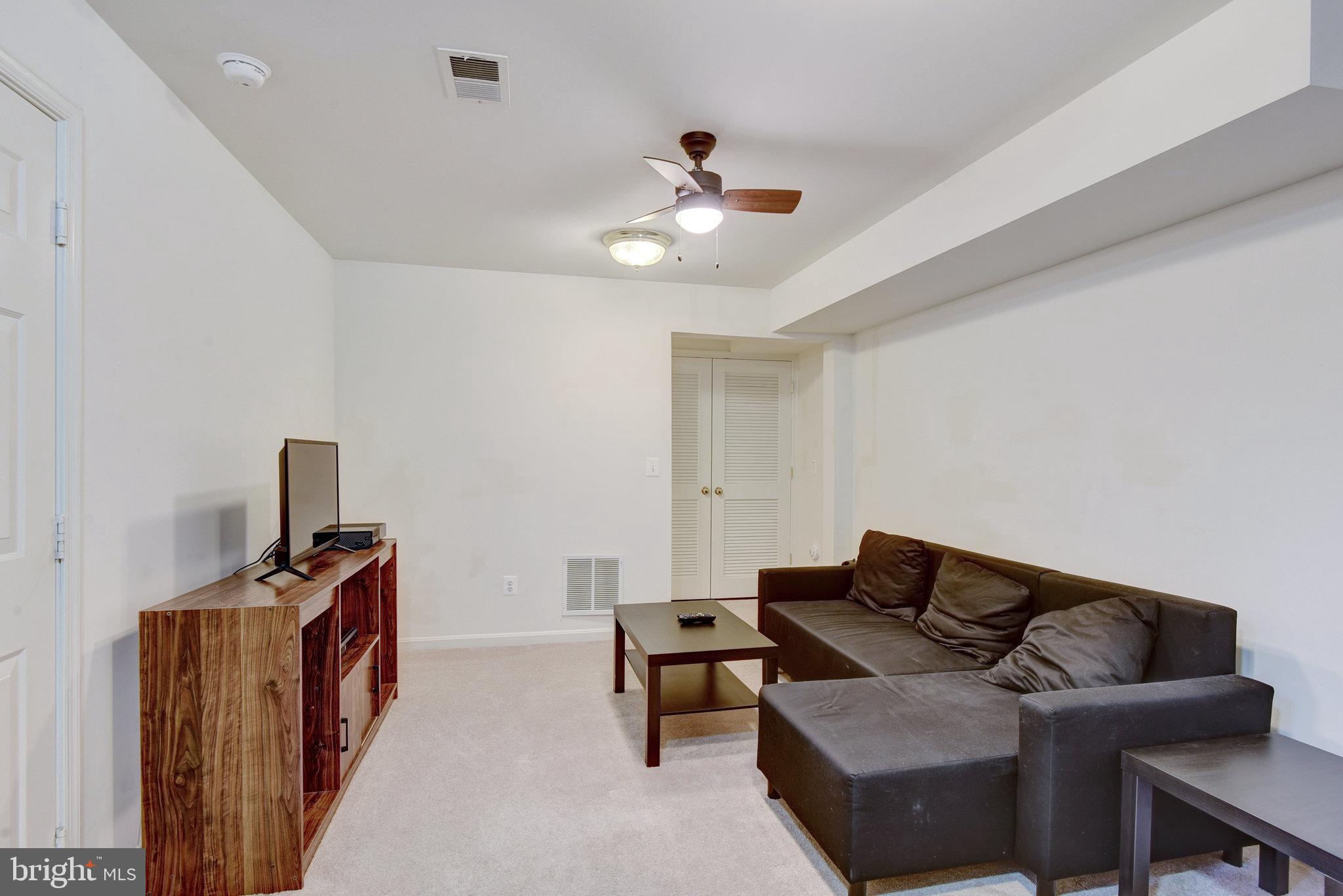 13017 Bath Gate Way Bristow, VA 20136 - Photo 32 of 35 a living room with furniture and a ceiling fan