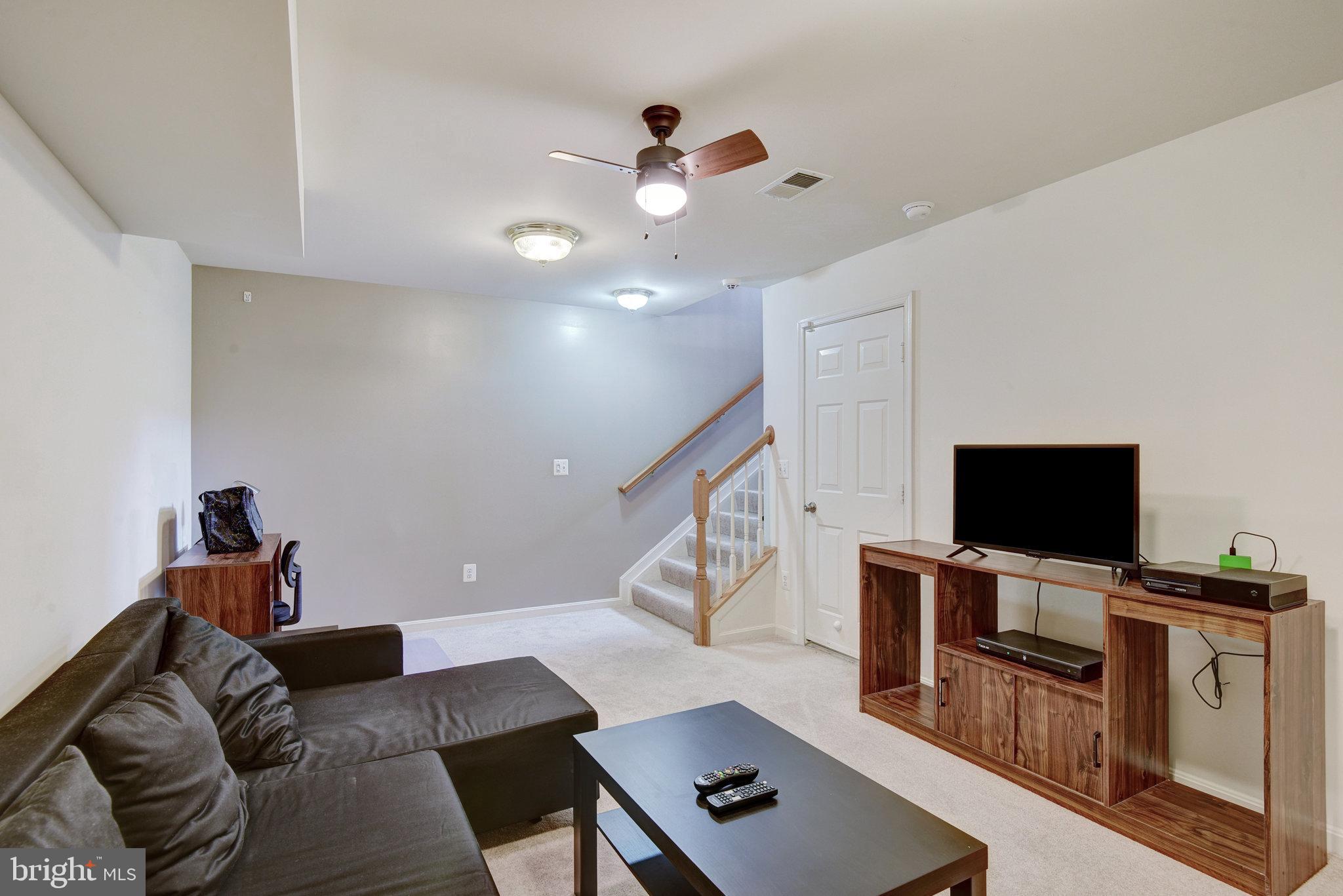 13017 Bath Gate Way Bristow, VA 20136 - Photo 33 of 35 a living room with furniture and a flat screen tv
