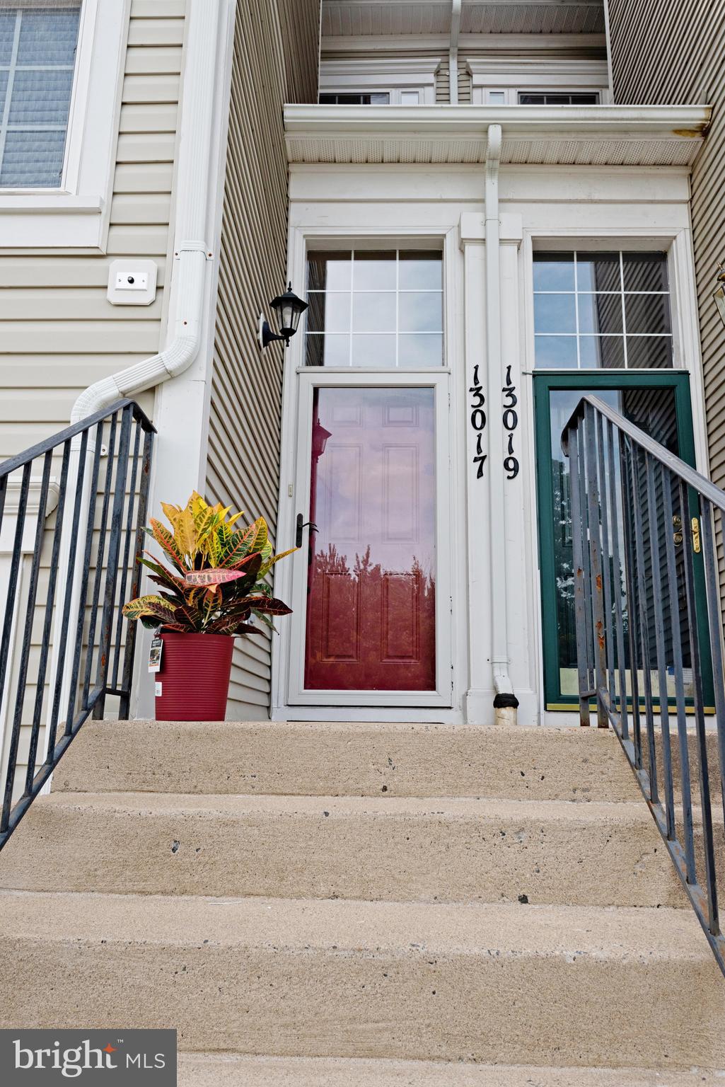 13017 Bath Gate Way Bristow, VA 20136 - Photo 6 of 35 a view of a brick building with a bench in front of house